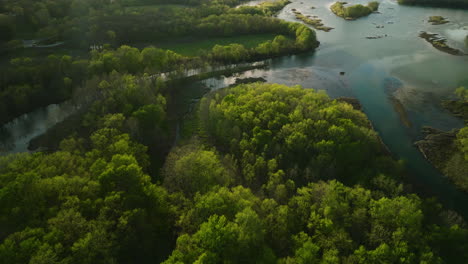 Sunset-aerial-view-over-Lake-Sequoyah-with-lush-greenery,-serene-waters