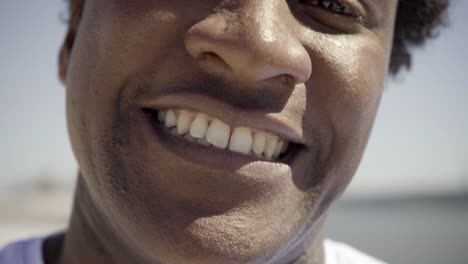 closeup shot of african american man with toothy smile