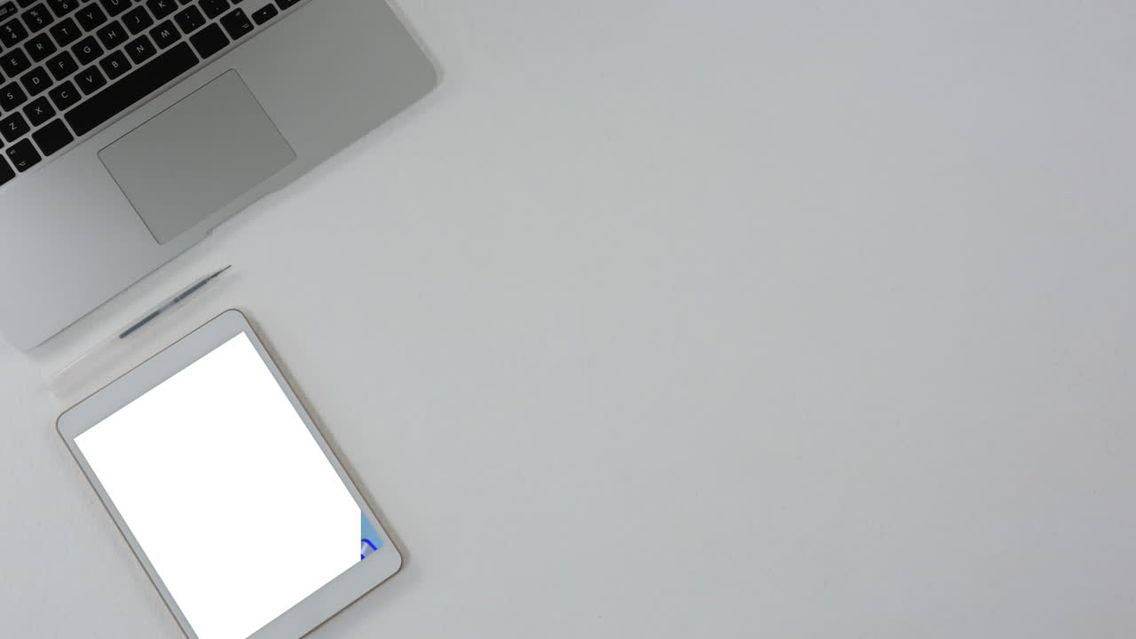 Video of tablet with blank screen and laptop with copy space on grey background