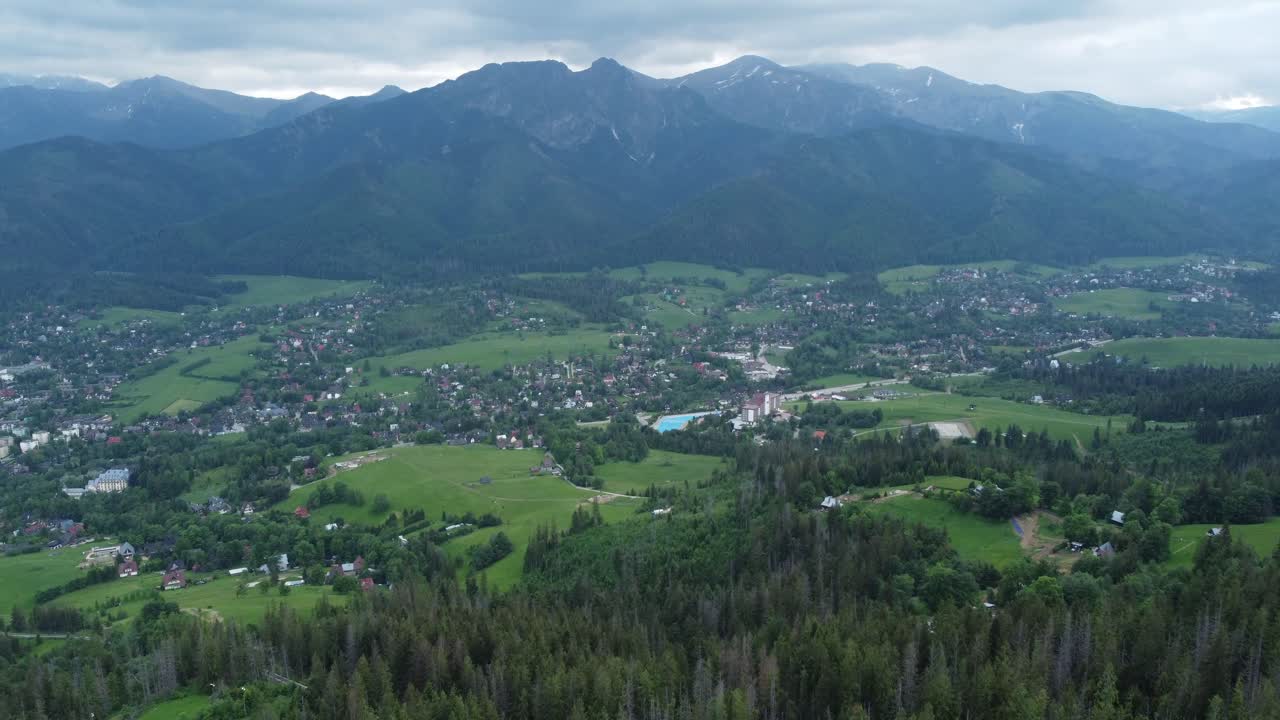 vista del valle desde gubałówka - sobrevuelo del paisaje de las montañas tatry polacas cubiertas de nieve, tierras de cultivo, bosques y el legendario pico giewont cerca de zakopane, polonia - 4k 30fps seguimiento suave hacia adelante-1