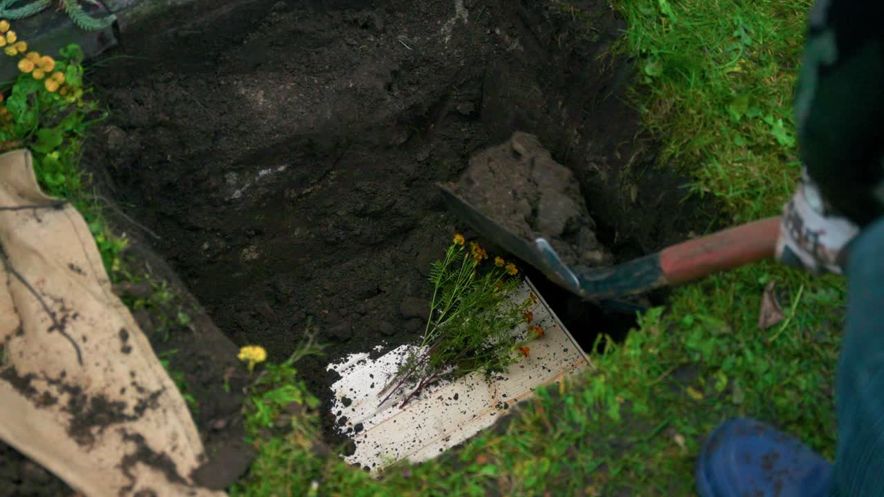 Person With Shovel Covers The Pit With Earth