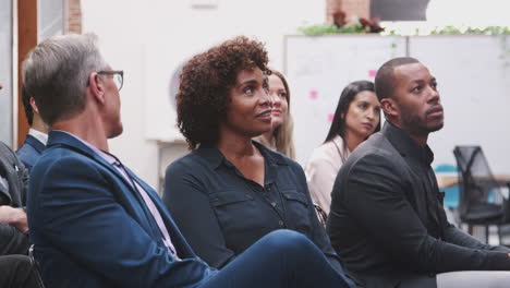 businessman asking speaker question at conference presentation