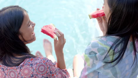 eating watermelon, two teenage girls hanging out by pool, enjoying summer
