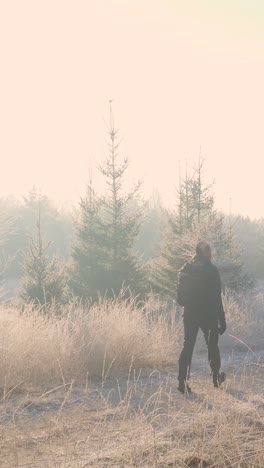 man hiking in a snowy forest