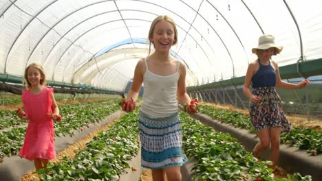 girls running with strawberries in the farm 4k