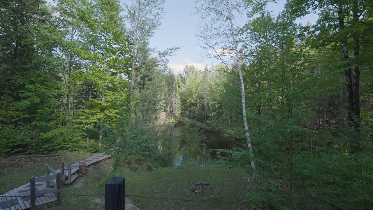 front door view coming out of cabin overlooking forest and lake