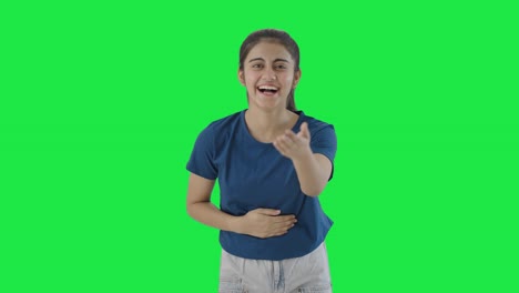 Happy-Indian-teenage-girl-laughing-on-someone-Green-screen