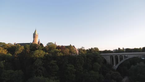 Cars-driving-over-a-bridge-over-a-valley-in-Luxembourg-city-at-sunset-on-a-summer-day