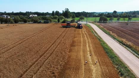 Aerial-Shot-of-Combine-Loading-Off-Corn-Grains-Into-Tractor-Trailer-7