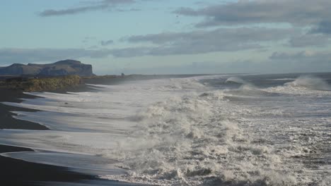 White-Ocean-Waves-Coming-To-The-Shore-Of-Black-Sand-Beach-In-Summer