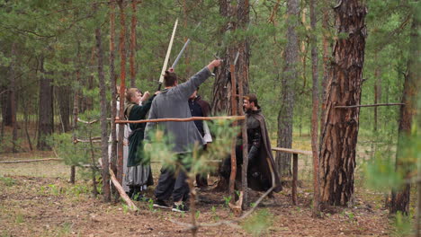 brave warriors raise up swords at training in fir wood