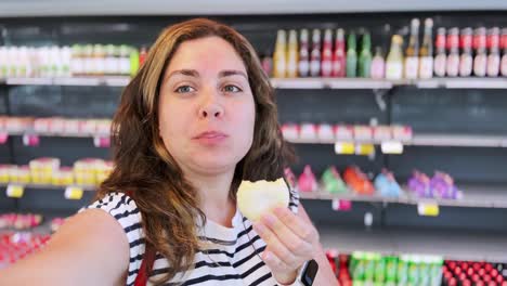 woman eating a snack in a grocery store