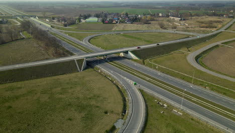 aerial tilt down view over highway exit ramp travel with traffic through cedry poland