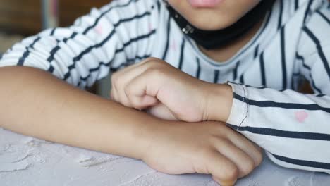 child girl suffering from itching skin, close up