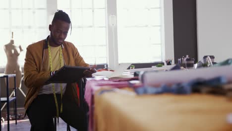 Mixed-race-man-working-in-fashion-office