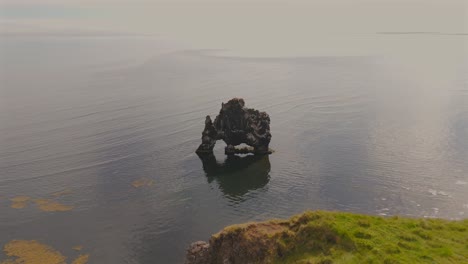 discover hvitserkur, iceland, through stunning drone footage that captures its iconic rock formation rising majestically from the north atlantic, surrounded by breathtaking landscapes.
