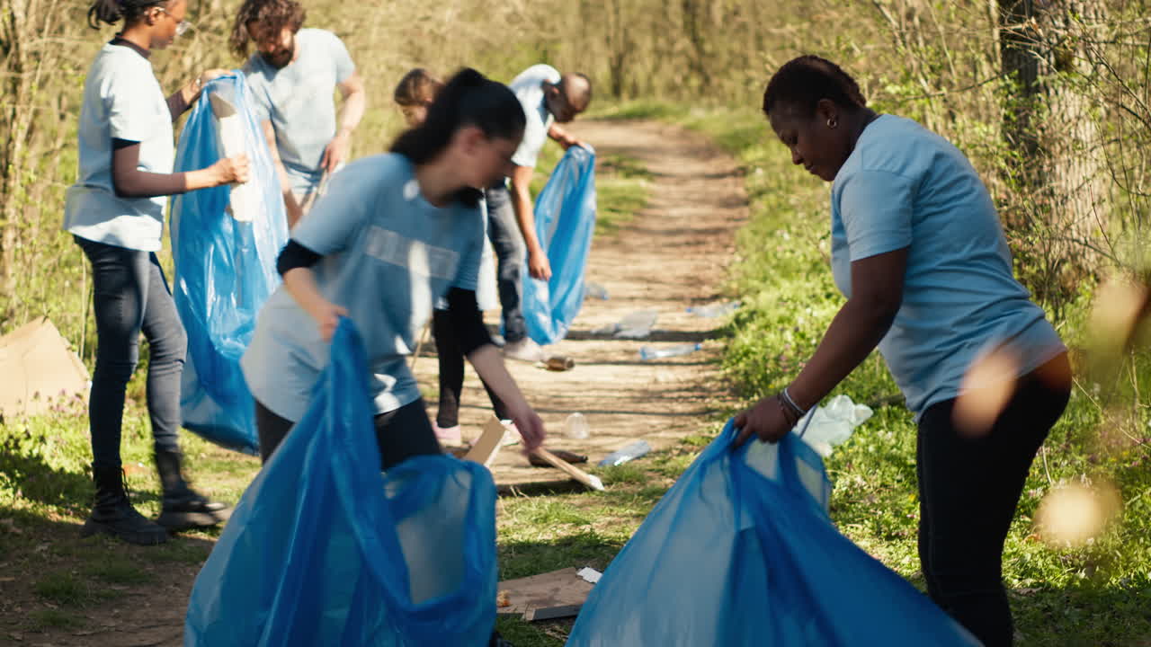 Diverse group of activists gathering to clean up a forest area