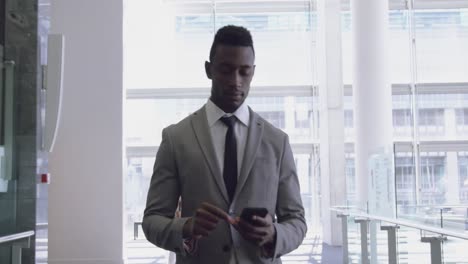 businessman using mobile phone in the corridor at office 4k