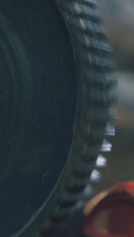 cu: professional forge-rolling machine tool with turning shaft operates in jewelry workshop on blurred background closeup