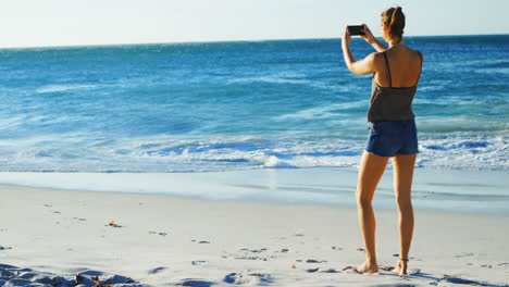 Female-volleyball-player-clicking-photos-with-mobile-phone-4k