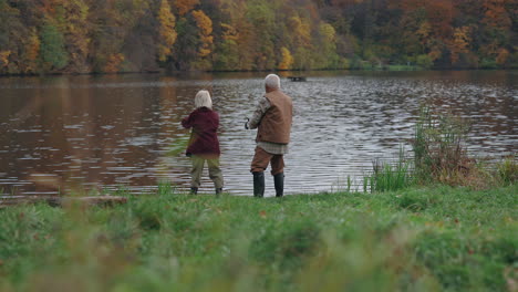 couple fishing by a lake in autumn