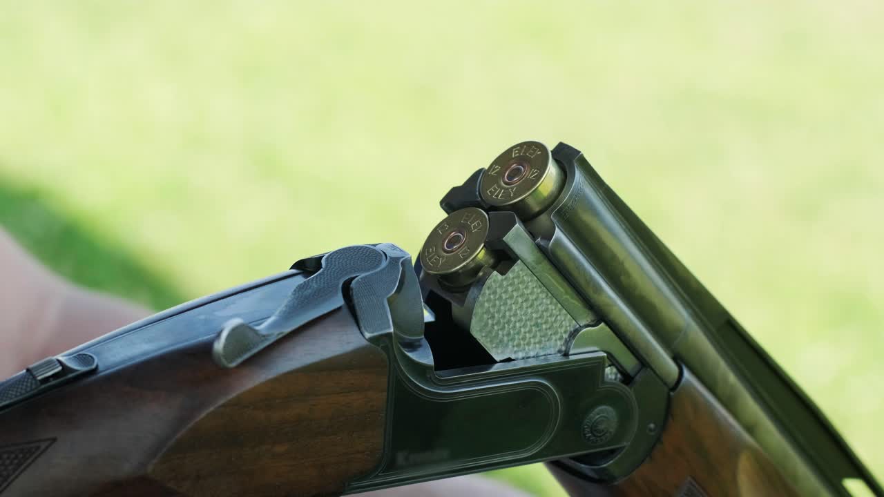 Sportsman shoots from a double-barreled shotgun, A sports field for a shooting test is shooting at flying skeet