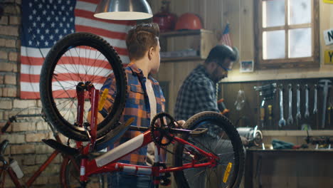 father and son repairing a bike in the garage