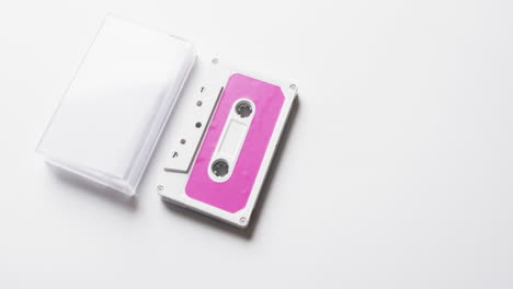 Video-of-retro-tape-with-pink-label-and-clear-box-with-copy-space-on-white-background