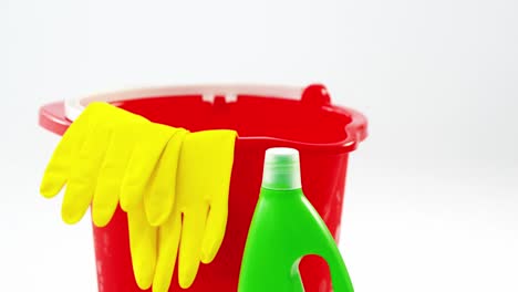 plastic bucket with glove and detergent