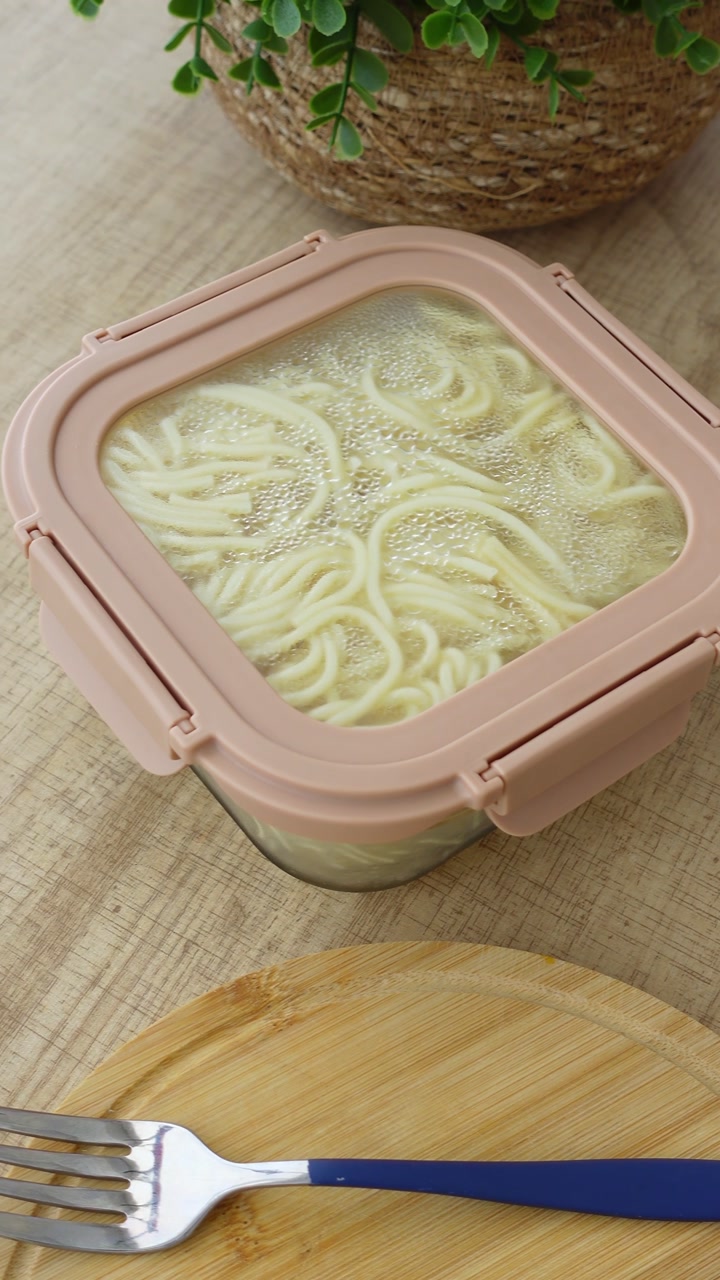 Freshly Cooked Noodles in a Pink-Lidded Container