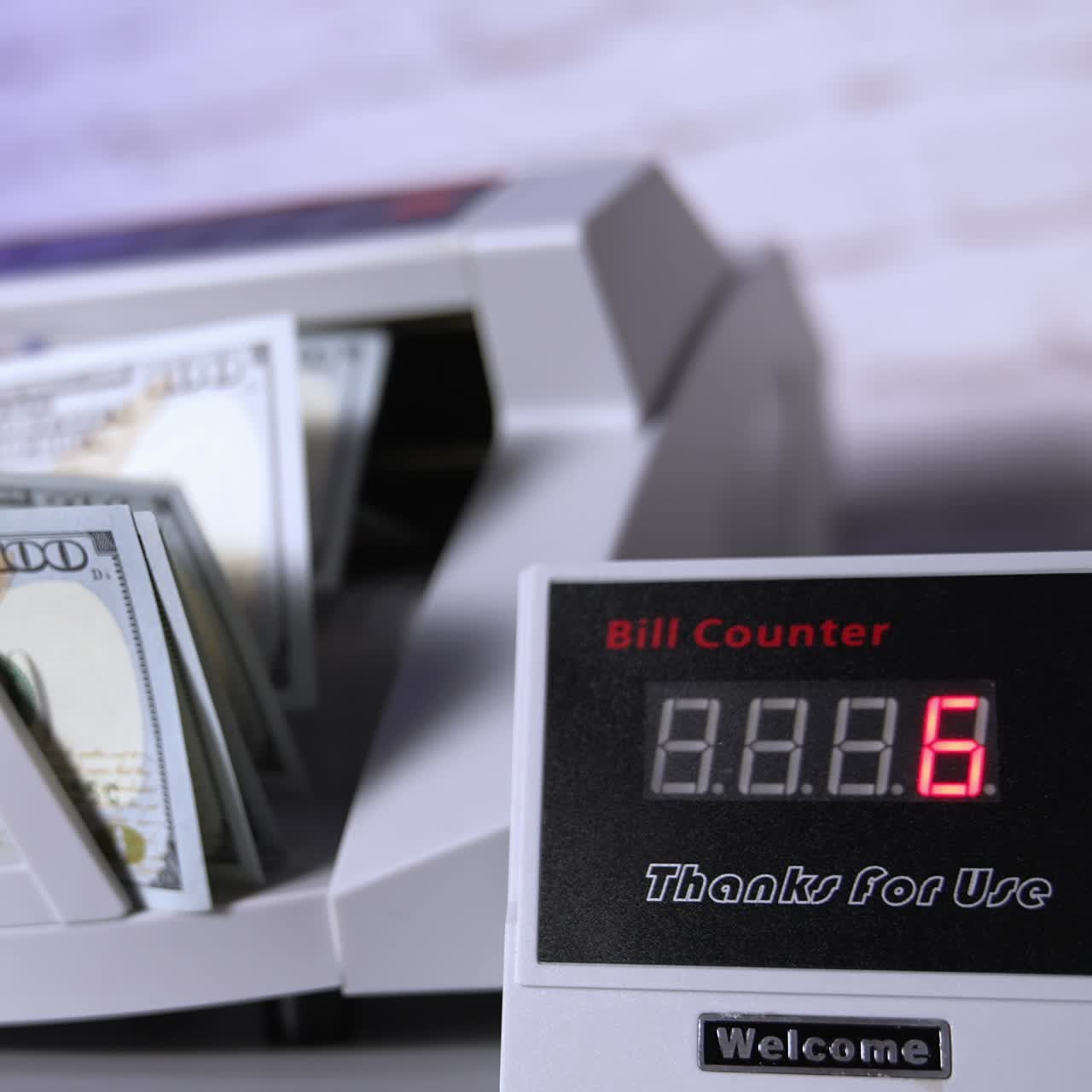 Person putting money at the banking modern counter. Special machine for counting banknotes. Money and business concept. Cropped view
