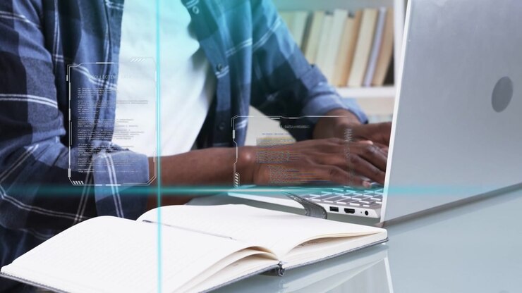 Man at glass desk starting typing, hands on keyboard, HUD grid sliding over hands aiding education