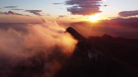 drone shot orbiting santuari de bellmunt in catalonia sunset