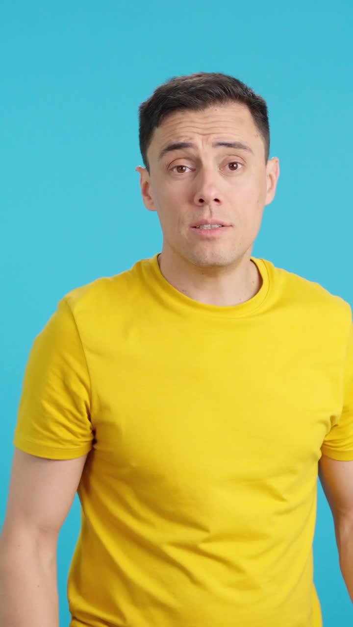 Man in yellow shirt making gestures