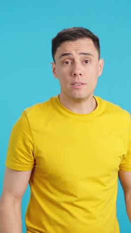 Man in yellow shirt making gestures