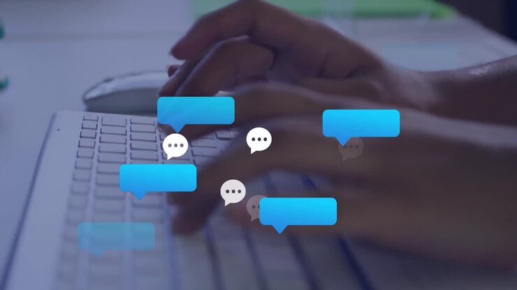 Animation of social media icons against mid section of a person typing on keyboard