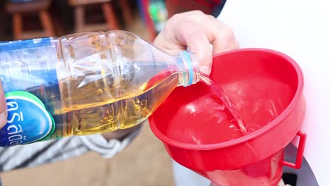 sequential pouring of amber liquid through funnel