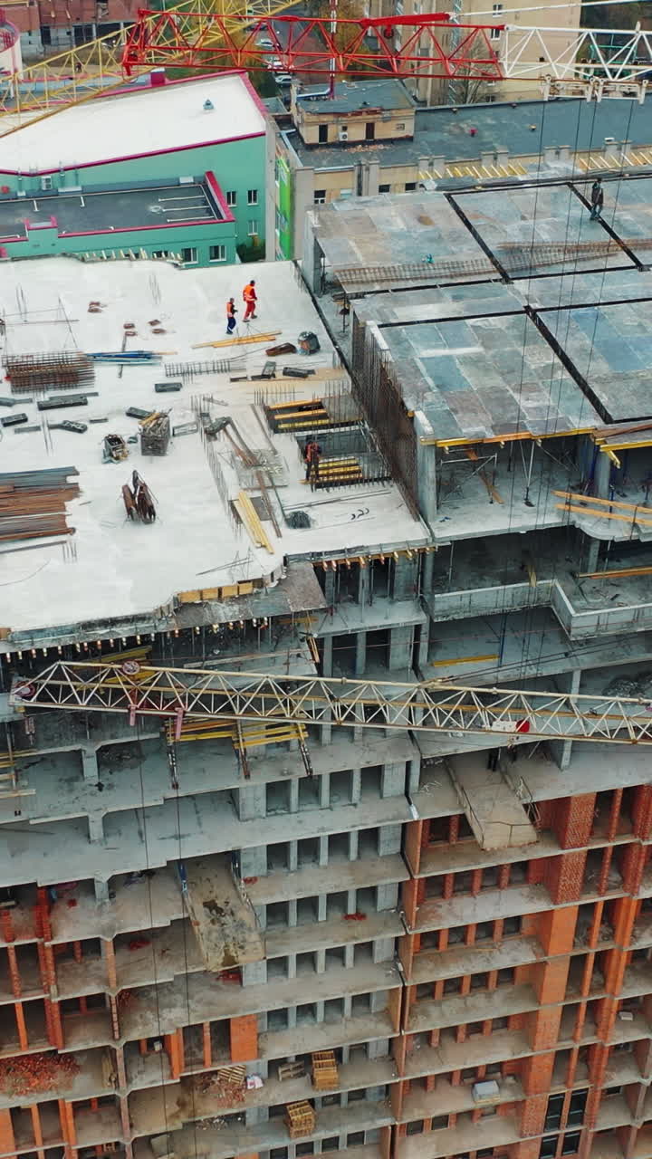 Construction of a residential apartment complex. Aerial view. Vertical video