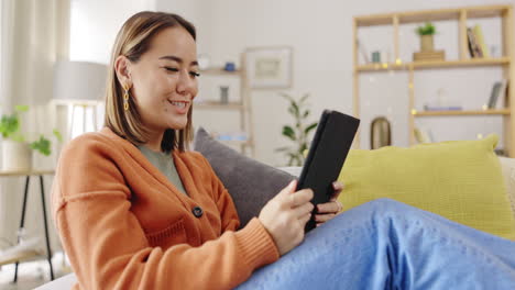 video call, sofa and woman on tablet waves hello