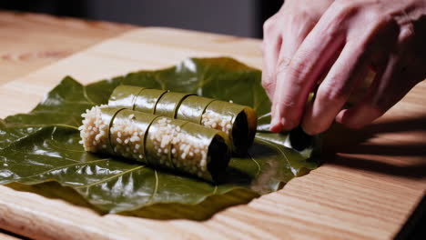 preparing dolmas: stuffed grape leaves