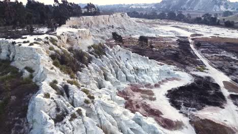 Aerial-drone-shot-passing-over-a-mineral-rich-mine-dump,-the-deposit-made-up-of-disregarded-tailings-from-an-old-gold-mine,-Benoni,-South-Africa