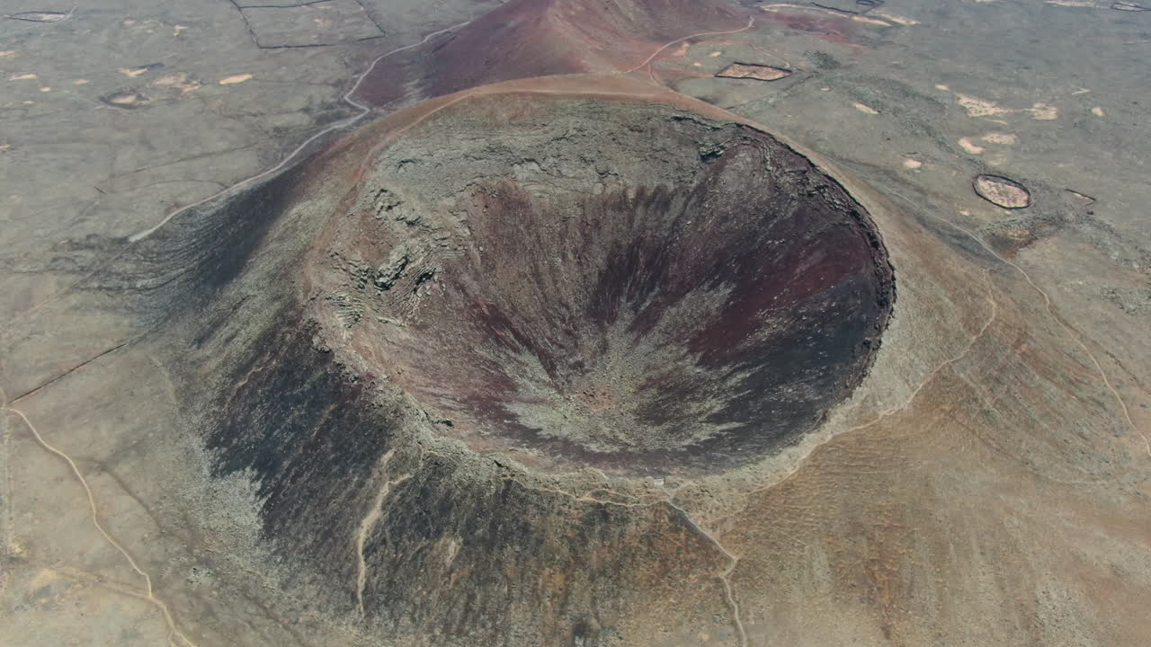 drone shot at high altitude over the crater of one of the Bayuyo Volcanoes is a set of volcanic cones that erupted at the same time, following an almost straight line.