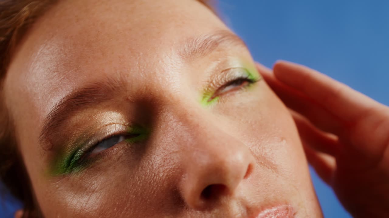 Close-up of a Woman's Face with Green Eyeshadow