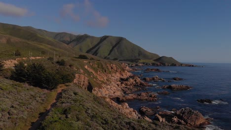 Hiking-path-along-coastal-highway-one-near-rocky-coastline-during-sunset