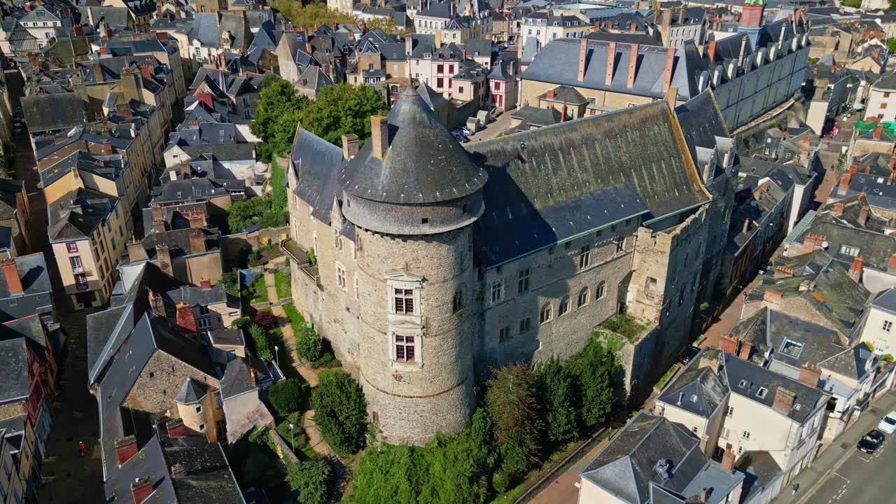 Detailed aerial close up of Chateau de Laval showing roof texture and stone walls, tracking right