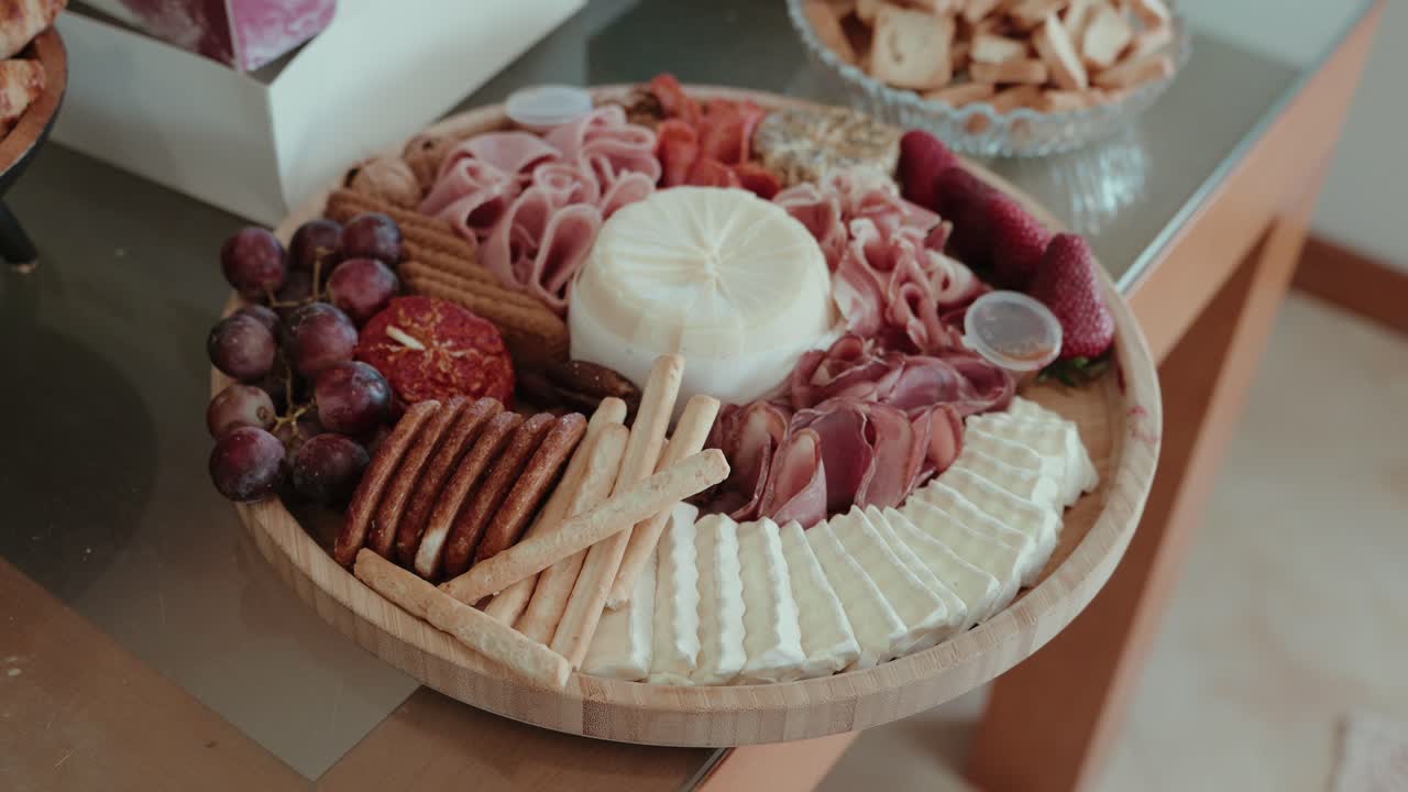 elegant wooden platter filled with cheese crackers ham and fruit