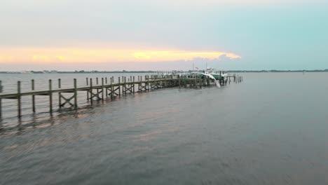 an aerial shot of the ocean water with piers near the shore