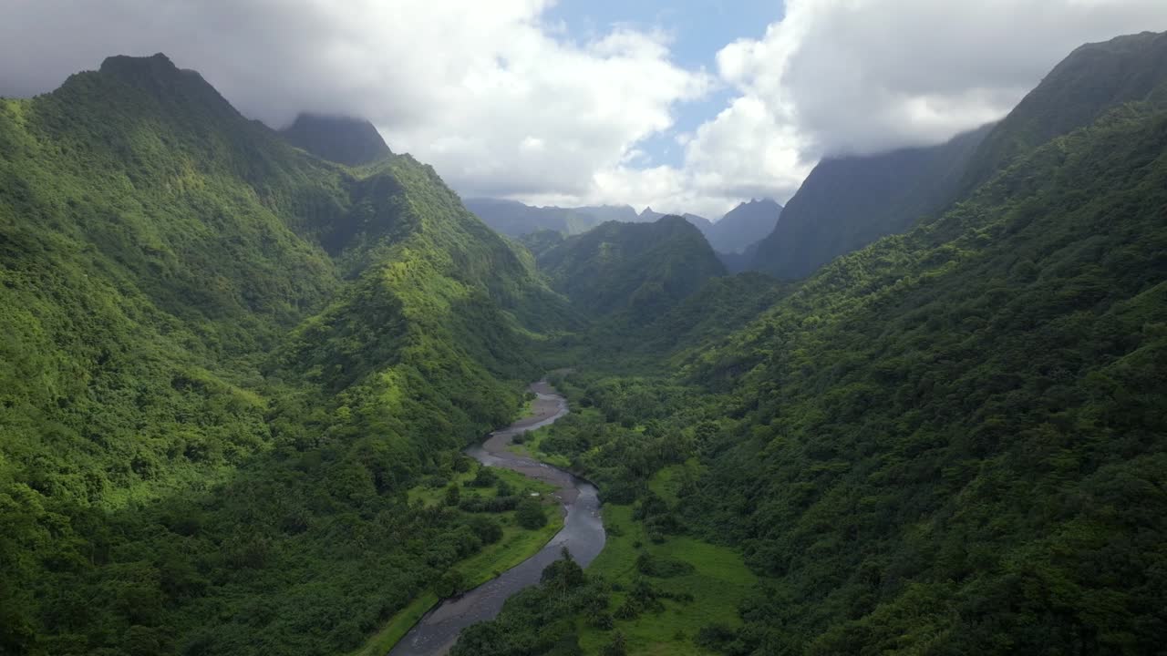 Valley Valle de Tautira Vaitia Teahupoo Mont Aorai Faretua North Shore Tahiti French Polynesia aerial drone Vaitepiha River Taravao canyon ravine jagged mountains green lush blue sky clouds backwards