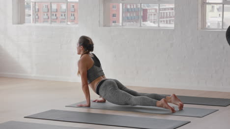 yoga class healthy women stretching preparing for morning workout practicing poses enjoying healthy lifestyle training in fitness studio