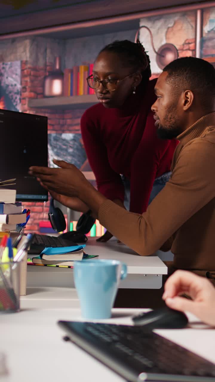 Vertical video Team of AI startup workers conducting code review on PC to fix bugs